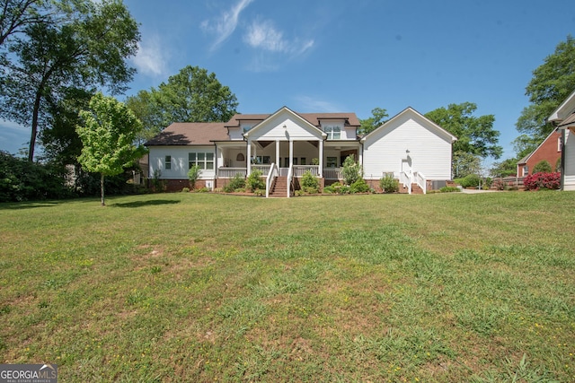 back of house featuring a yard and a porch