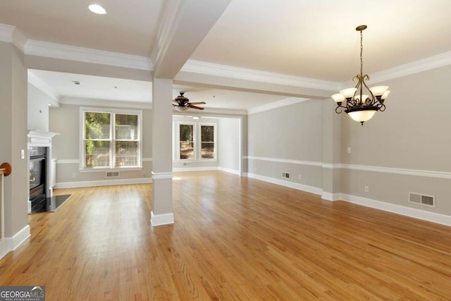 unfurnished living room featuring light wood-style floors, visible vents, baseboards, and a fireplace with flush hearth