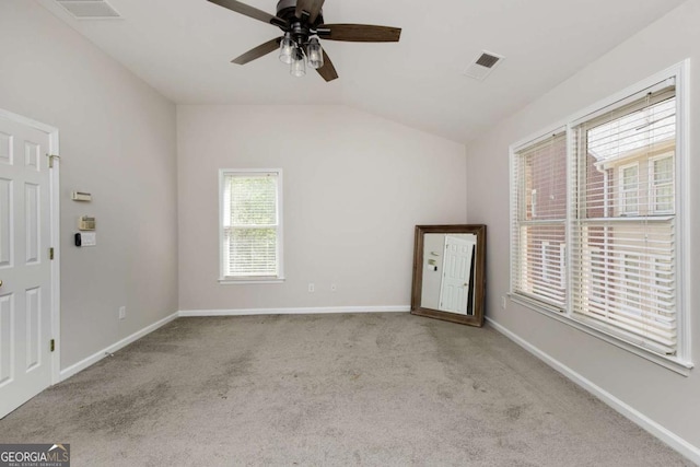 spare room with baseboards, carpet floors, a ceiling fan, and visible vents