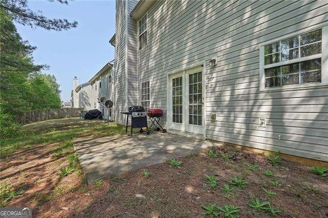 415 Clairidge Ln SW, Lawrenceville, GA 30046 - view of side of home featuring a chimney, fence, and a patio area