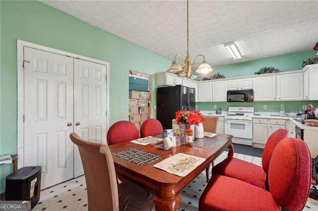 415 Clairidge Ln SW, Lawrenceville, GA 30046 - dining area featuring light floors, an inviting chandelier, and a textured ceiling