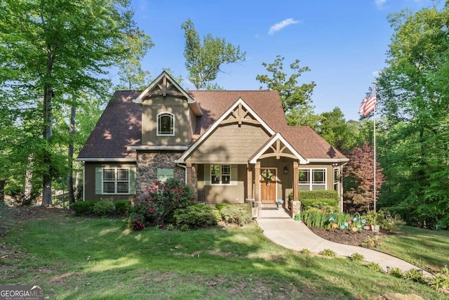 210 Lake Pines Rd, Jackson, GA 30233 - craftsman-style home featuring a front yard and stone siding