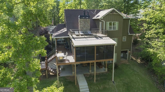 210 Lake Pines Rd, Jackson, GA 30233 - rear view of house with a lawn, stairway, a chimney, and a sunroom