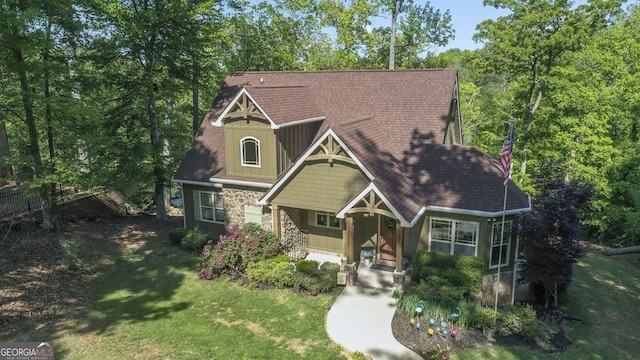 210 Lake Pines Rd, Jackson, GA 30233 - craftsman-style home featuring covered porch, board and batten siding, a front lawn, and stone siding