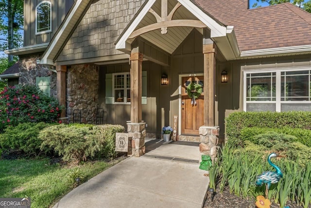 210 Lake Pines Rd, Jackson, GA 30233 - doorway to property featuring board and batten siding, a porch, roof with shingles, and stone siding