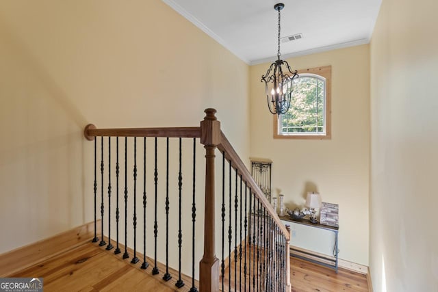 210 Lake Pines Rd, Jackson, GA 30233 - stairway featuring visible vents, wood finished floors, an inviting chandelier, and crown molding
