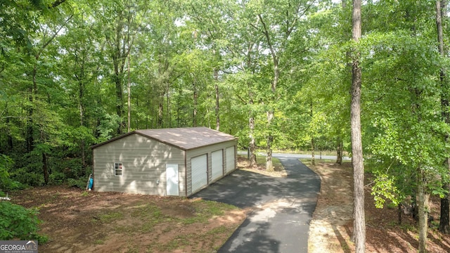 210 Lake Pines Rd, Jackson, GA 30233 - view of outbuilding with an outdoor structure and a view of trees
