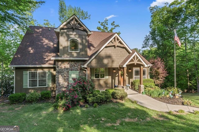 210 Lake Pines Rd, Jackson, GA 30233 - craftsman-style house with board and batten siding, a front lawn, and stone siding