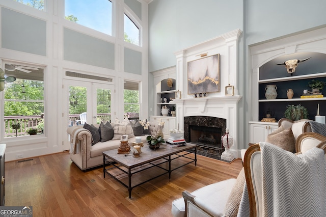 3190 Shumard Way, Marietta, GA 30064 - living room featuring wood finished floors, built in features, a wealth of natural light, and a high end fireplace