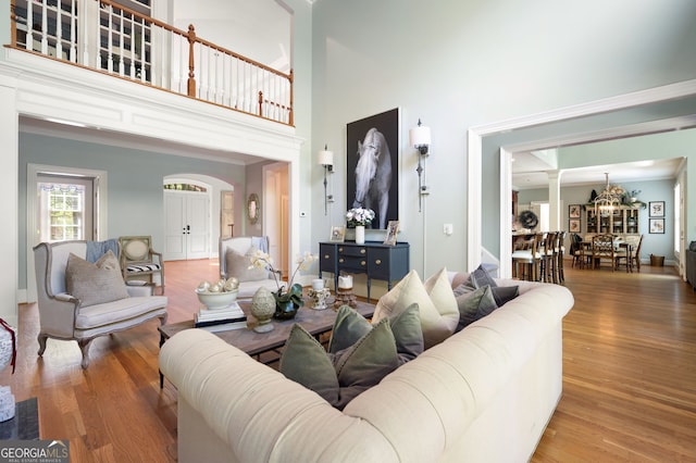 3190 Shumard Way, Marietta, GA 30064 - living room featuring arched walkways, a high ceiling, wood finished floors, and ornate columns