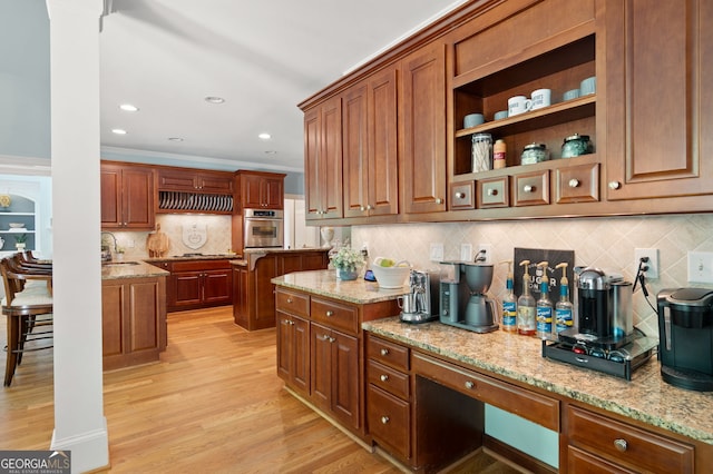 3190 Shumard Way, Marietta, GA 30064 - kitchen featuring a sink, stainless steel oven, light wood-type flooring, decorative backsplash, and light stone countertops