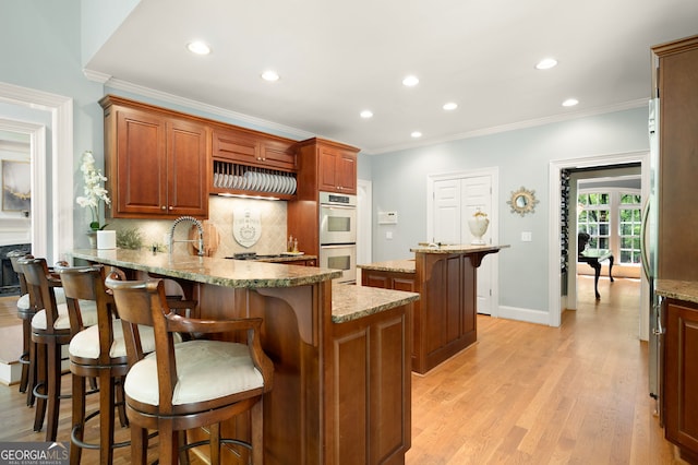 3190 Shumard Way, Marietta, GA 30064 - kitchen featuring recessed lighting, ornamental molding, decorative backsplash, appliances with stainless steel finishes, and a breakfast bar area