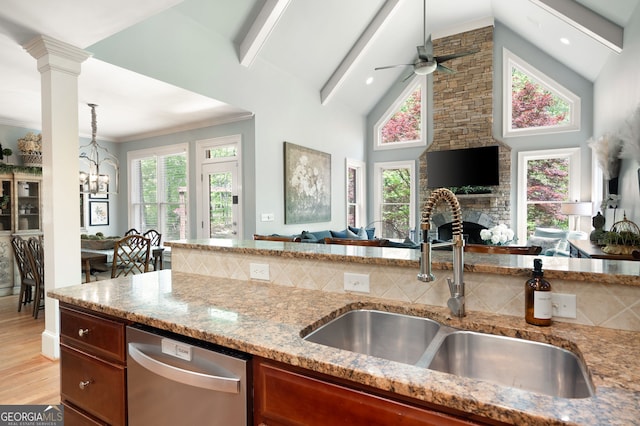 3190 Shumard Way, Marietta, GA 30064 - kitchen with stainless steel dishwasher, a sink, light stone countertops, open floor plan, and ceiling fan with notable chandelier
