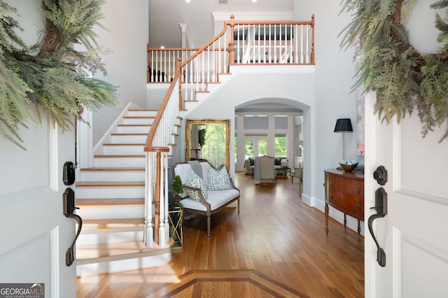 3190 Shumard Way, Marietta, GA 30064 - entrance foyer featuring wood finished floors, a high ceiling, arched walkways, and stairs