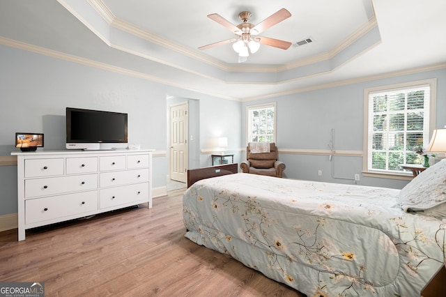 3190 Shumard Way, Marietta, GA 30064 - bedroom with visible vents, light wood-style flooring, a tray ceiling, and multiple windows