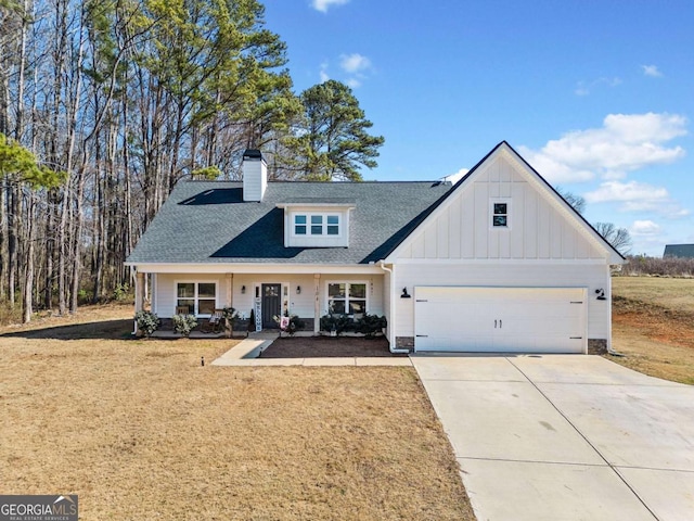 modern farmhouse style home featuring board and batten siding, driveway, a chimney, roof with shingles, and a garage