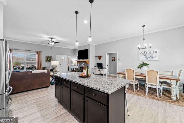 104 Federal Path, Temple, GA 30179 - kitchen with freestanding refrigerator, a ceiling fan, a chandelier, ornamental molding, and light wood-style floors