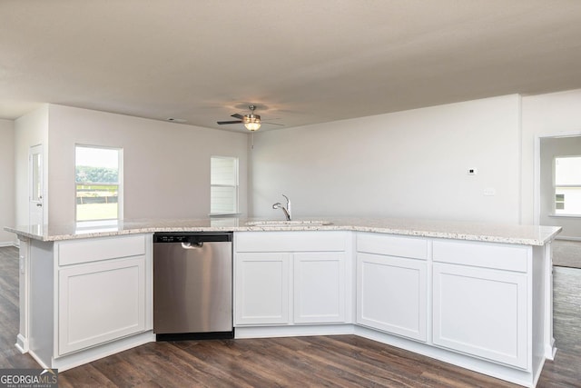 kitchen featuring a ceiling fan, a sink, dishwasher, dark wood-style flooring, and light stone countertops
