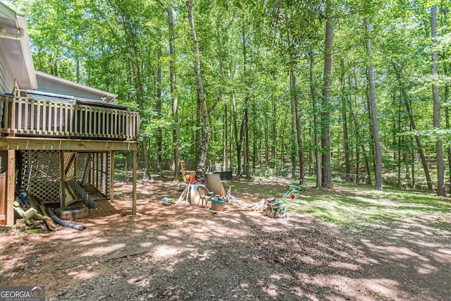 146 Highland Cir, Mcdonough, GA 30253 - view of yard featuring a deck, a forest view, and stairs