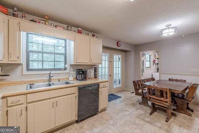146 Highland Cir, Mcdonough, GA 30253 - kitchen with dishwasher, a sink, light countertops, a textured ceiling, and cream cabinetry