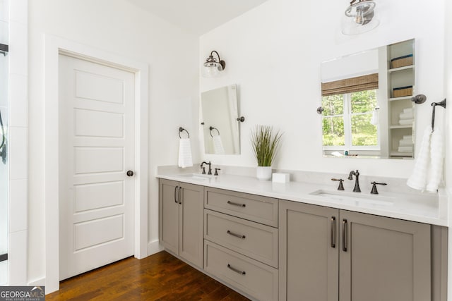 1630 Dogwood Dr, Greensboro, GA 30642 - bathroom featuring double vanity, wood finished floors, and a sink