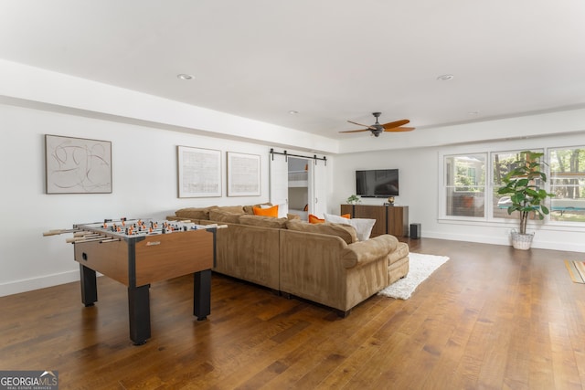 1630 Dogwood Dr, Greensboro, GA 30642 - living area with a barn door, wood finished floors, ceiling fan, baseboards, and recessed lighting