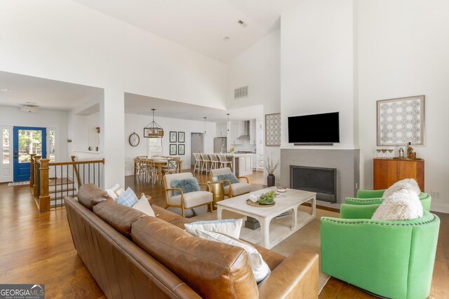 1630 Dogwood Dr, Greensboro, GA 30642 - living area with a high ceiling, wood finished floors, visible vents, and a fireplace