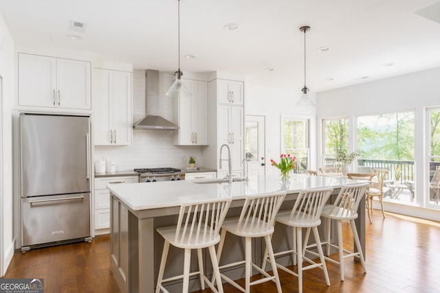 1630 Dogwood Dr, Greensboro, GA 30642 - kitchen with high end refrigerator, wall chimney range hood, tasteful backsplash, a sink, and stove
