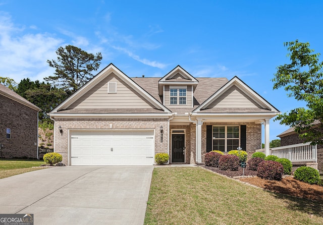 5749 Creek Indian Dr, Sugar Hill, GA 30518 - craftsman house with an attached garage, a front lawn, brick siding, and concrete driveway