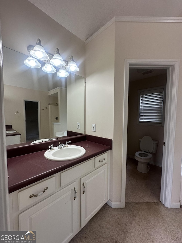 bathroom with baseboards, vanity, toilet, and tile patterned floors
