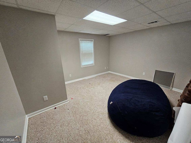 sitting room with a drop ceiling, carpet flooring, and baseboards