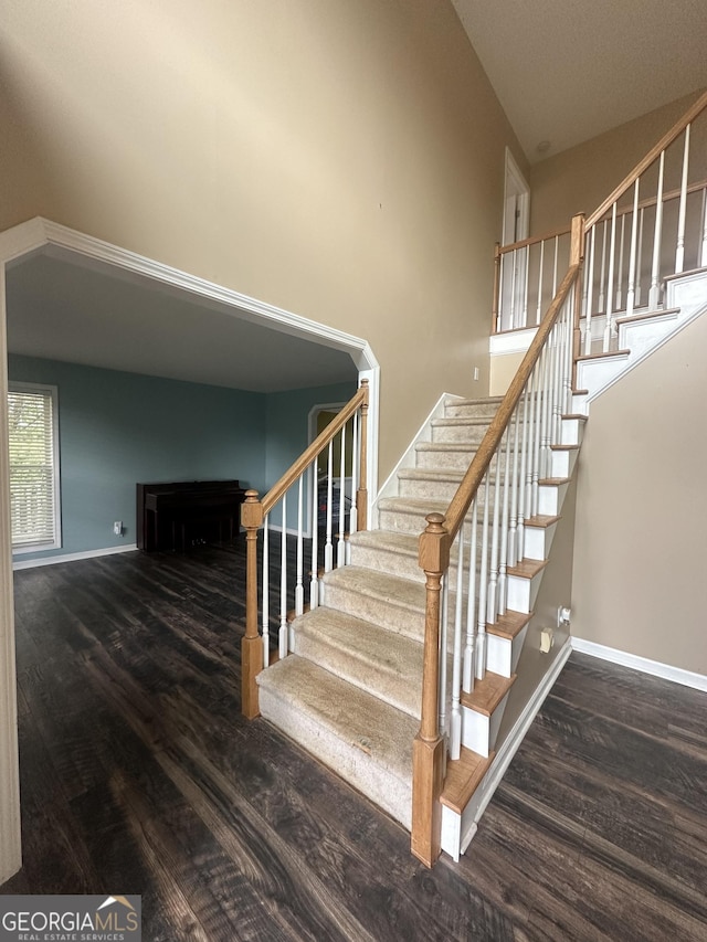 stairway featuring wood finished floors and baseboards