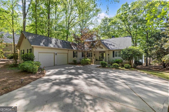 129 Barrington Hall Dr, Eatonton, GA 31024 - single story home with driveway, roof with shingles, and a garage