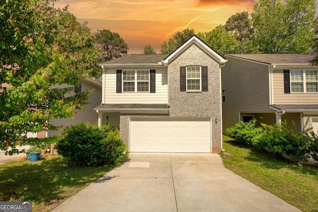 11224 Aliyah Dr, Hampton, GA 30228 - view of front facade with a garage, driveway, brick siding, and a lawn