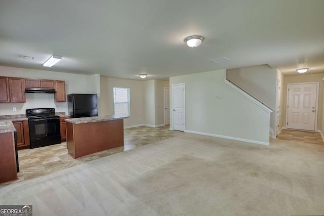 11224 Aliyah Dr, Hampton, GA 30228 - kitchen featuring a center island, light countertops, extractor fan, and black appliances