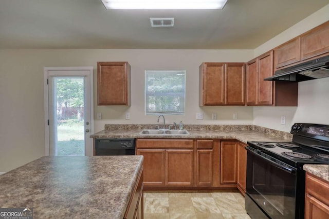 11224 Aliyah Dr, Hampton, GA 30228 - kitchen with a sink, brown cabinetry, black appliances, under cabinet range hood, and visible vents