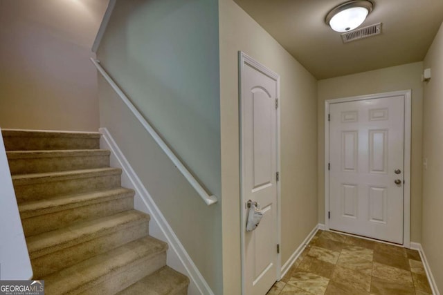 11224 Aliyah Dr, Hampton, GA 30228 - staircase with stone finish floor, visible vents, and baseboards