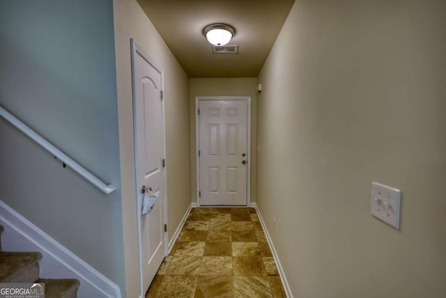 11224 Aliyah Dr, Hampton, GA 30228 - hallway featuring stone finish flooring, baseboards, stairs, and visible vents