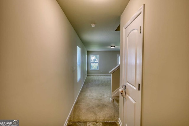 11224 Aliyah Dr, Hampton, GA 30228 - hallway featuring carpet flooring, baseboards, and an upstairs landing