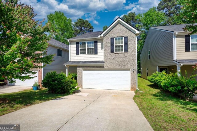 11224 Aliyah Dr, Hampton, GA 30228 - view of front of property featuring a garage, driveway, a front lawn, and brick siding