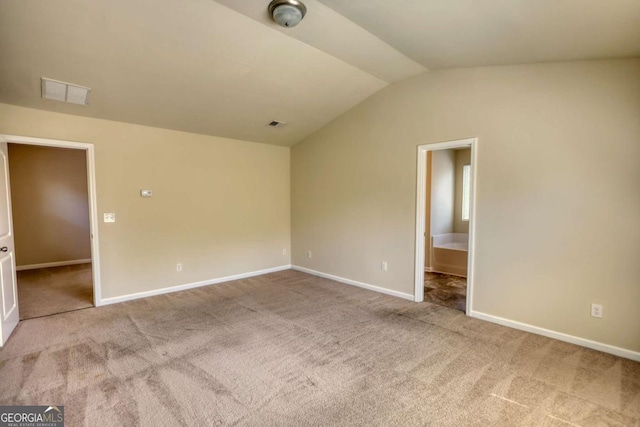 11224 Aliyah Dr, Hampton, GA 30228 - unfurnished bedroom featuring lofted ceiling, carpet floors, baseboards, and visible vents
