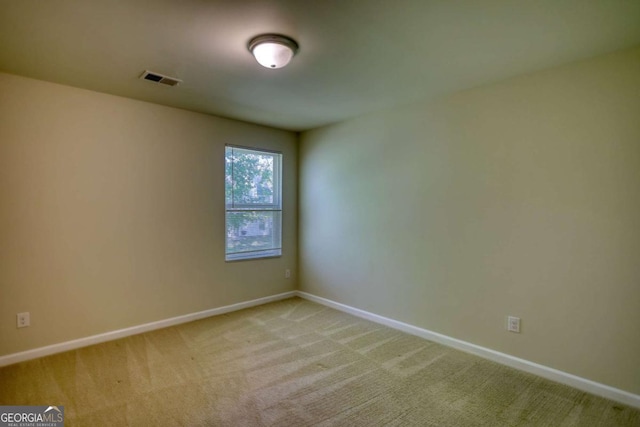 11224 Aliyah Dr, Hampton, GA 30228 - spare room featuring light carpet, visible vents, and baseboards