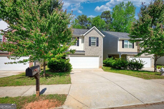 11224 Aliyah Dr, Hampton, GA 30228 - view of front of house with concrete driveway, an attached garage, and brick siding