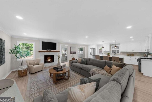 7300 Wynhill Dr, Sandy Springs, GA 30328 - living area featuring recessed lighting, ornamental molding, light wood-type flooring, baseboards, and a fireplace