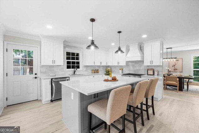 7300 Wynhill Dr, Sandy Springs, GA 30328 - kitchen featuring backsplash, stainless steel dishwasher, a sink, a kitchen island, and custom range hood