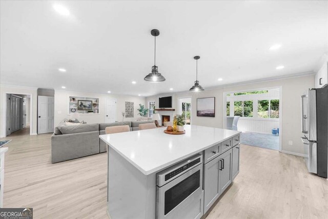 7300 Wynhill Dr, Sandy Springs, GA 30328 - kitchen featuring gray cabinets, stainless steel appliances, light wood finished floors, ornamental molding, and recessed lighting