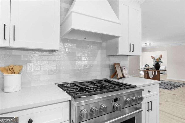 7300 Wynhill Dr, Sandy Springs, GA 30328 - kitchen with premium range hood, stainless steel stove, light countertops, and white cabinets