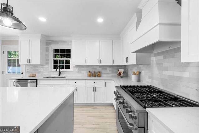7300 Wynhill Dr, Sandy Springs, GA 30328 - kitchen with appliances with stainless steel finishes, tasteful backsplash, a sink, and custom range hood