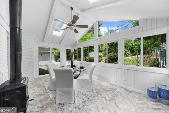 7300 Wynhill Dr, Sandy Springs, GA 30328 - sunroom / solarium with vaulted ceiling with skylight, a wood stove, and plenty of natural light