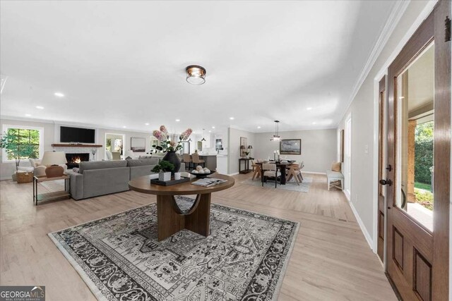 7300 Wynhill Dr, Sandy Springs, GA 30328 - living area with a warm lit fireplace, light wood finished floors, baseboards, ornamental molding, and recessed lighting